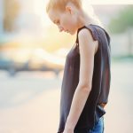Emotive young beautiful woman posing on the street